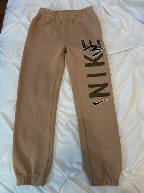 Nike Kids Tan Joggers with Bold Side Logo. Youth Large (12-13 yrs old)
